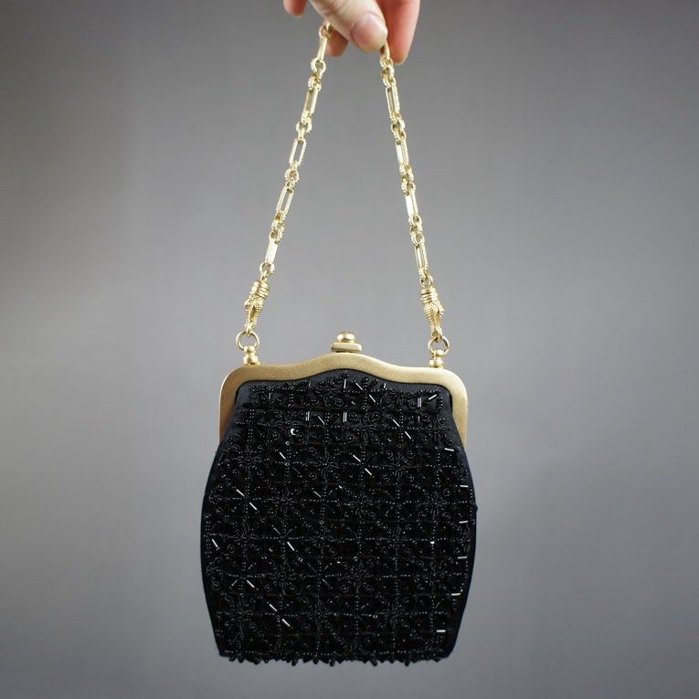 Kieselstein-Cord black beaded satin evening bag with alligator brushed gold vermeil over sterling silver chain-link strap and hardware. This BKC bag features a framed top with push-lock closure, four light gold-tone feet at bottom of bag, inside