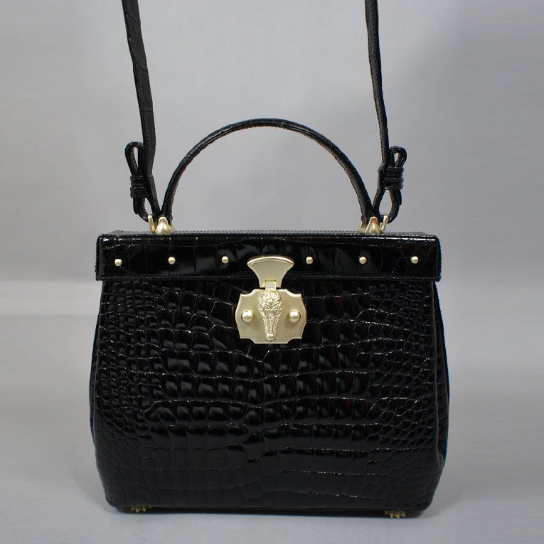 Kieselstein-Cord shiny black alligator Lombard bag with brushed gold vermeil over sterling silver hardware (color is a white gold). This BKC bag features a top flap alligator head push-lock closure, a black handle strap and an optional shoulder