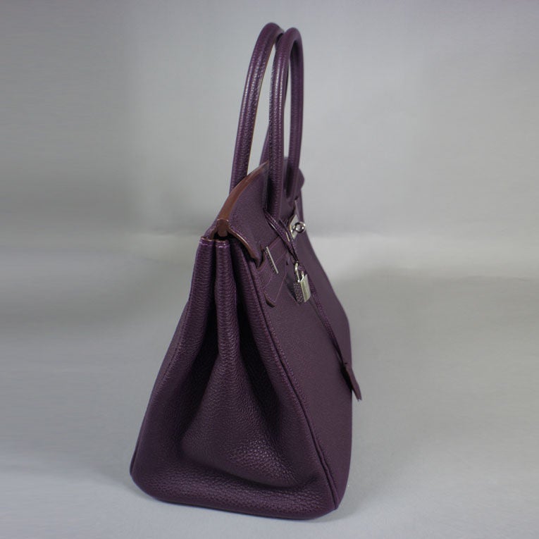 Hermès raisin (purple) Birkin 35cm with signature palladium hardware in Togo leather, matching strap, clochette. The bag is pristine & exquisitely colored, blindstamp L. Interior is lined in chevre (goatskin) leather, and features a side pocket and