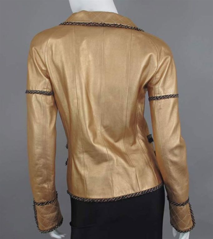 CHANEL metallic copper lambskin leather jacket. The jacket has a Peter Pan collar, front quilted details, hidden front zipper closure, four hip level slit pockets, Chanel charm, long sleeves with quilted slit cuffs.  Black and multicolor tweed