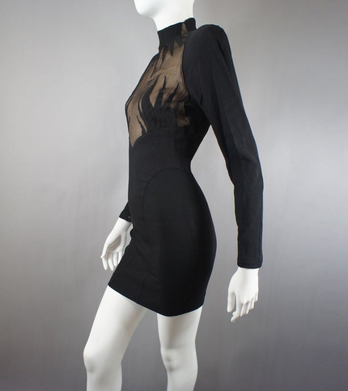 Thierry Mugler Vintage Long sleeve Black Starbust Dress from the 1980s. This hot party dress is a sure show stopper. The front features a sheer center with starbursts extending to cover parts of the chest. The neck is a short collar. It is very