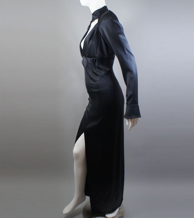 CHANEL elegant black silk floor-length gown with mock turtleneck, v-neckline and bell sleeves. Perfect for a formal affair and stays true to the brand's classic look: exudes formality as well as a playful sex-kitten vibe. The neck closes with 3