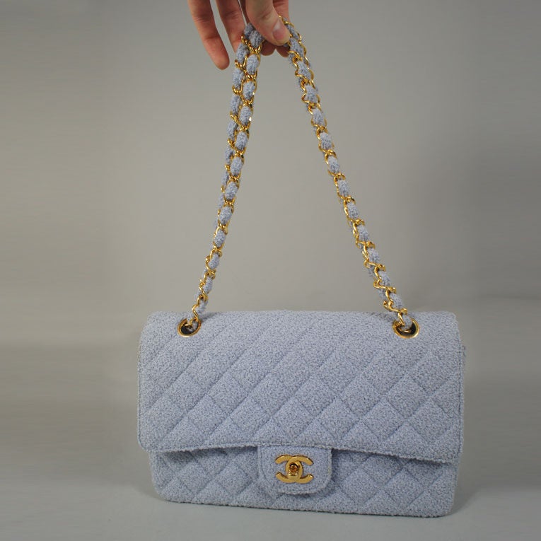 CHANEL vintage lavender (purple) boucle flap bag with gold tone hardware. This pale purple color and light fabric are great for spring as a pop of color. This bag features a CC turnkey lock on the front and half moon slip pocket on the back. The