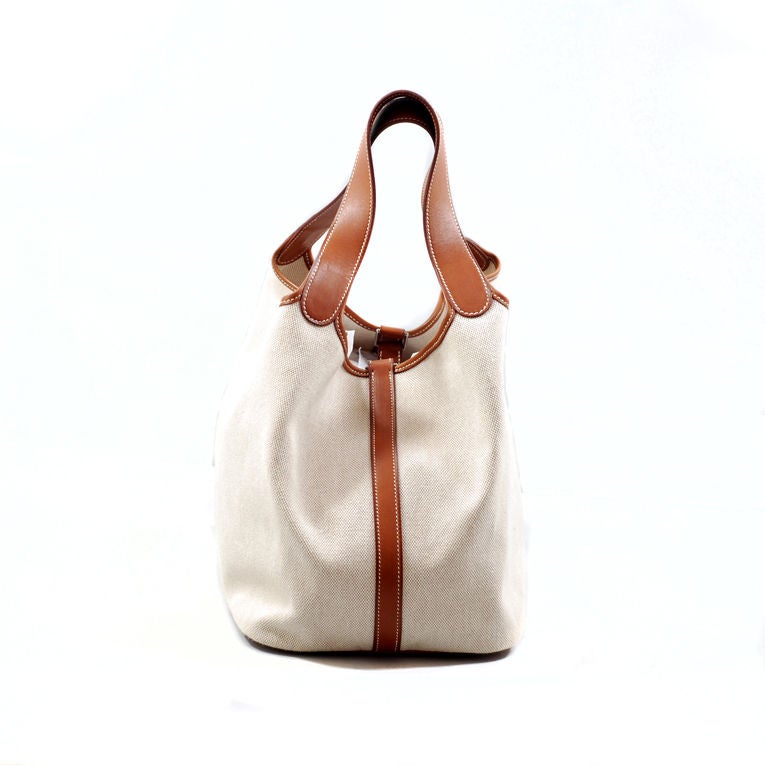 Hermes natural veau barenia and toile Picotin in large, GM size with palladium hardware. This neutral color bag is perfect for the summer season, and large enough to carry all you need! The bag has white contrast stitching, two handles and a strap