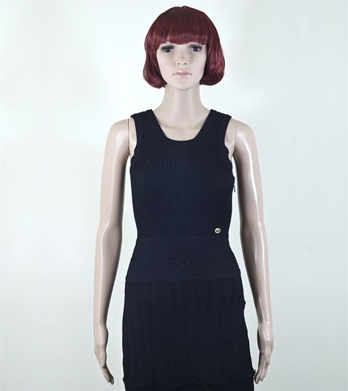 CHANEL fitted, stretchy black knit sleeveless dress in size FR 36 US 4 from the 07P collection. This Chanel forever favorite features ribbed knit top with elegant chantilly crochet pattern skirt with scalloped trim. Gold tone CC button at left front
