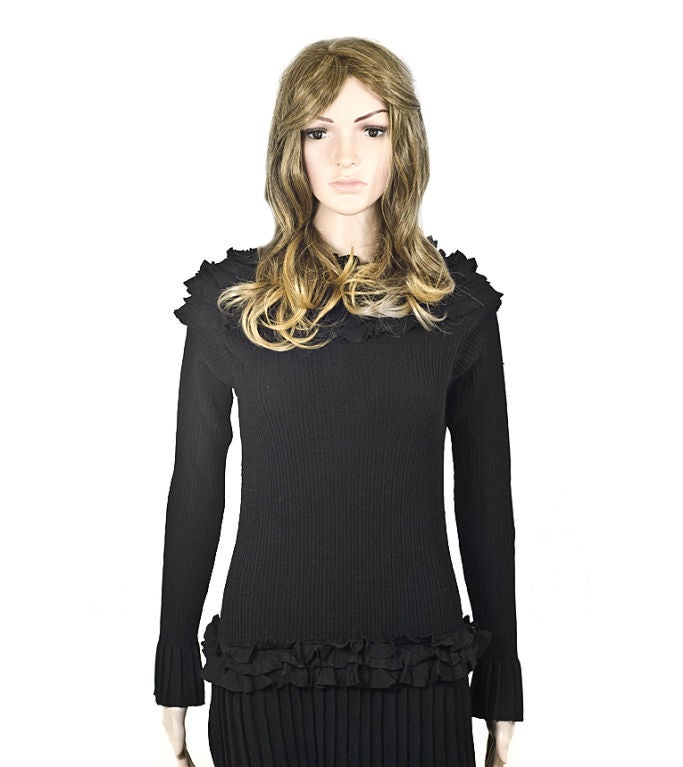 Louis Vuitton black knit long sleeve cocktail dress with elegant (four) ruffle collar and drop waist with ruffles as well as pleated bottom and sleeve cuffs. New with tags, mint condition. Great for an autumn LBD. <br />
<br />
Size: L (Best fits