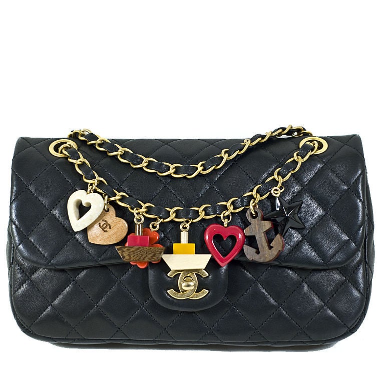 CHANEL 11C black lambskin charm bag with eight nautical charms and gold-tone hardware. This bag is new, never carried with original retail and Chanel tags. The chain strap has eight nautical themed charms, a star, anchor, hearts, clover, and small