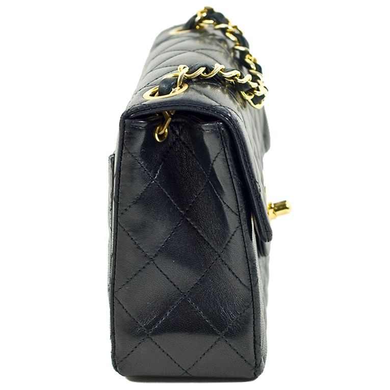 CHANEL vintage black lambskin quilted flap shoulder bag with gold-tone hardware. Front flap has classic turnkey CC closure and the well known Chanel moon shaped back pocket. Inside leather interior features slip pocket as well as zipper compartment