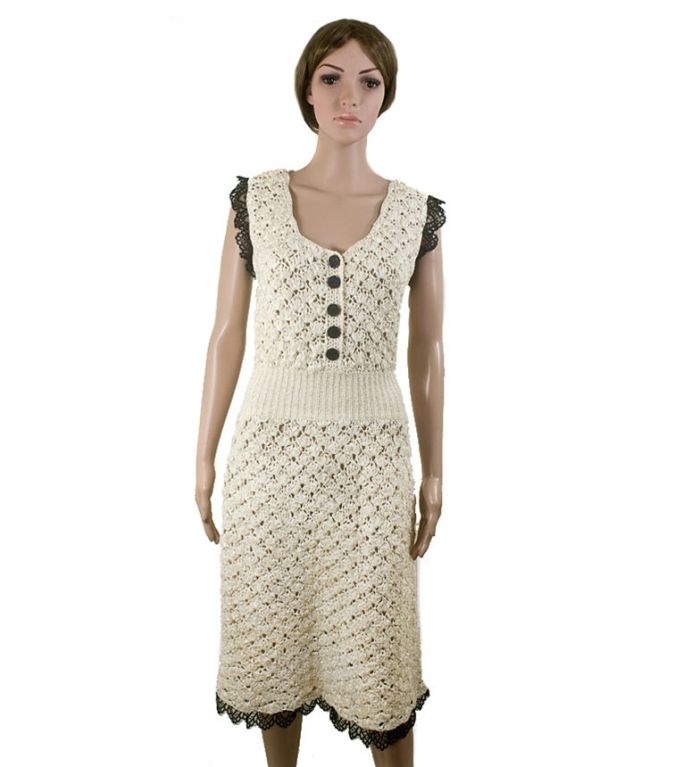 CHANEL ivory colored 100% silk crochet dress featuring black lace trim from the 08P collection.  Features five sparkly black gemstone speckled CC buttons along the front bust closure, a gathered waist and ornate silk open weave pattern throughout. 