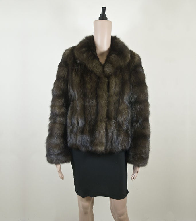 This Maximilian sable fur jacket is the ultimate in luxury. The variations in color of the brown sable create a subtle tiered effect. Its two pockets and a ow collar will keep you warm and chic all winter in this beautiful, wearable fur.<br />
<br