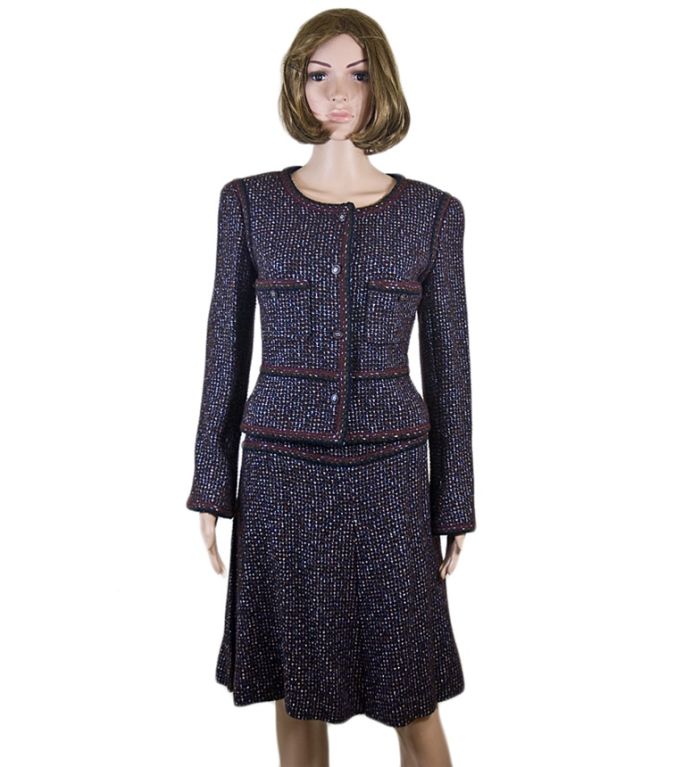 Chanel 02A classic fantasy tweed boucle skirt suit in a deep burgundy with a tweed of burgundy, black, silver and gold with similar woven trim throughout.  Timeless and elegant. Chanel 2002 fall fantasy tweed boucle in burgundy with black, silver,