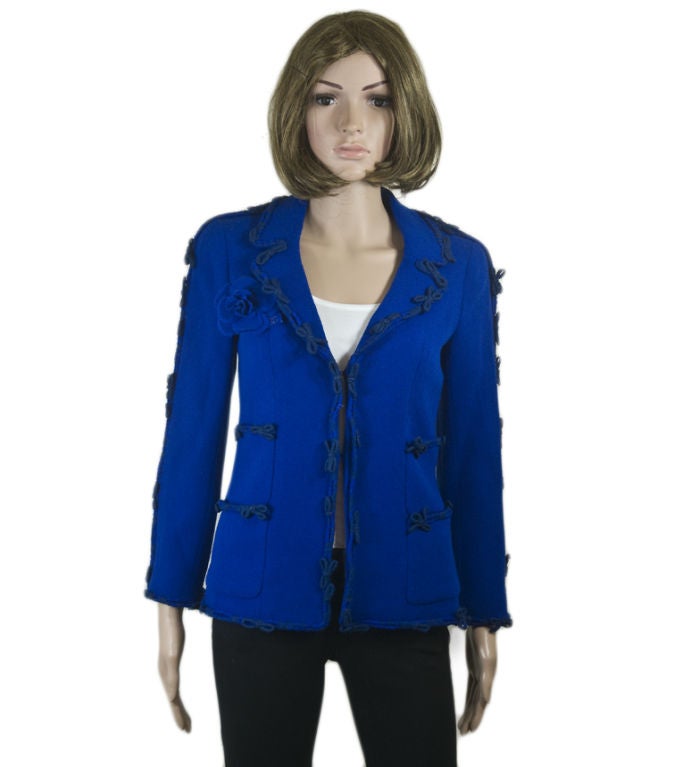 Chanel 07A royal blue wool-blend jacket.  Accented with petite bow details, sparkling clover CC logo buttons, and a detachable rose brooch with a blue CC charm, this bright jacket is feminine and unique.<br />
<br />
Chanel 07A blue wool-blend