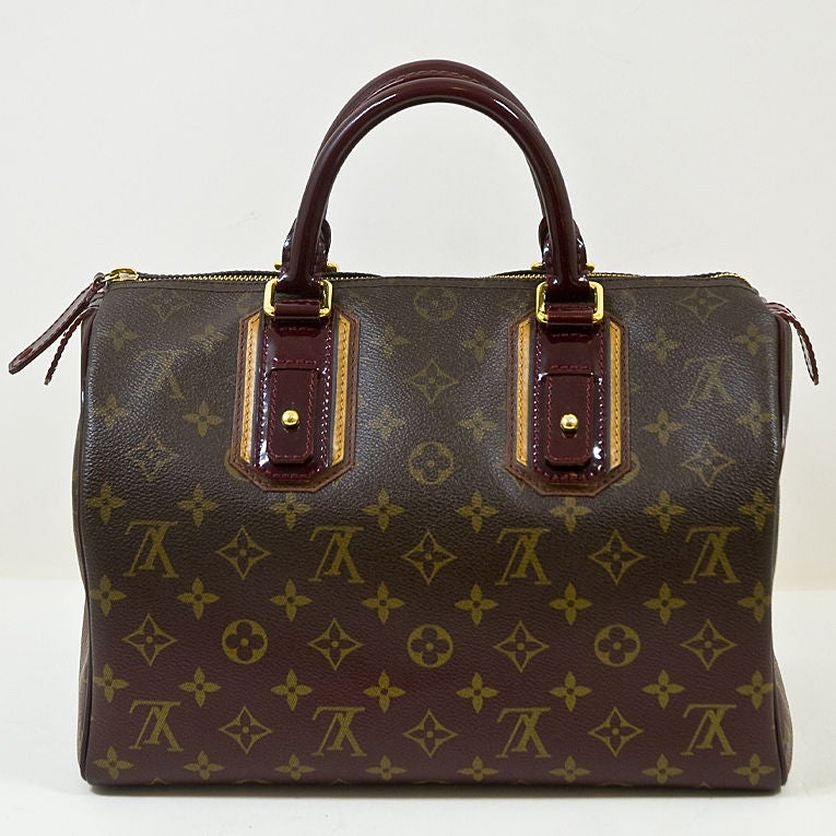 onogrammed coated canvas that fades to a beautiful Bordeaux color updates the classic Louis Vuitton Speedy 30 silhouette. Detailed with Bordeaux patent leather handles and gold hardware. The zipper pull has a gold LV lock that comes with two gold