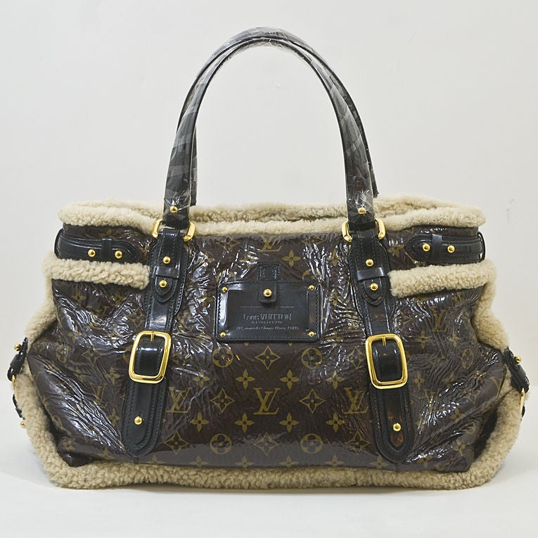 Louis Vuitton Thunder bag seen on the Fall 2007 runway. Produced in a limited edition, this bag features signature LV monogram patent leather with shearling trim and lining. Gold hardware and black patent calfskin handles, this unique bag puts a