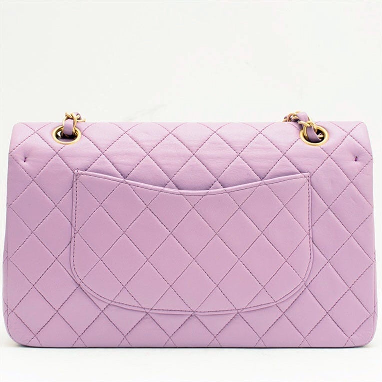 Chanel purple 2.55 double flap bag
    Lambskin leather with gold-tone hardware
    Features a CC turnkey lock on front flap and half moon back slip packet
    Interior is calfskin leather with two open pockets, and one zipper pocket under the