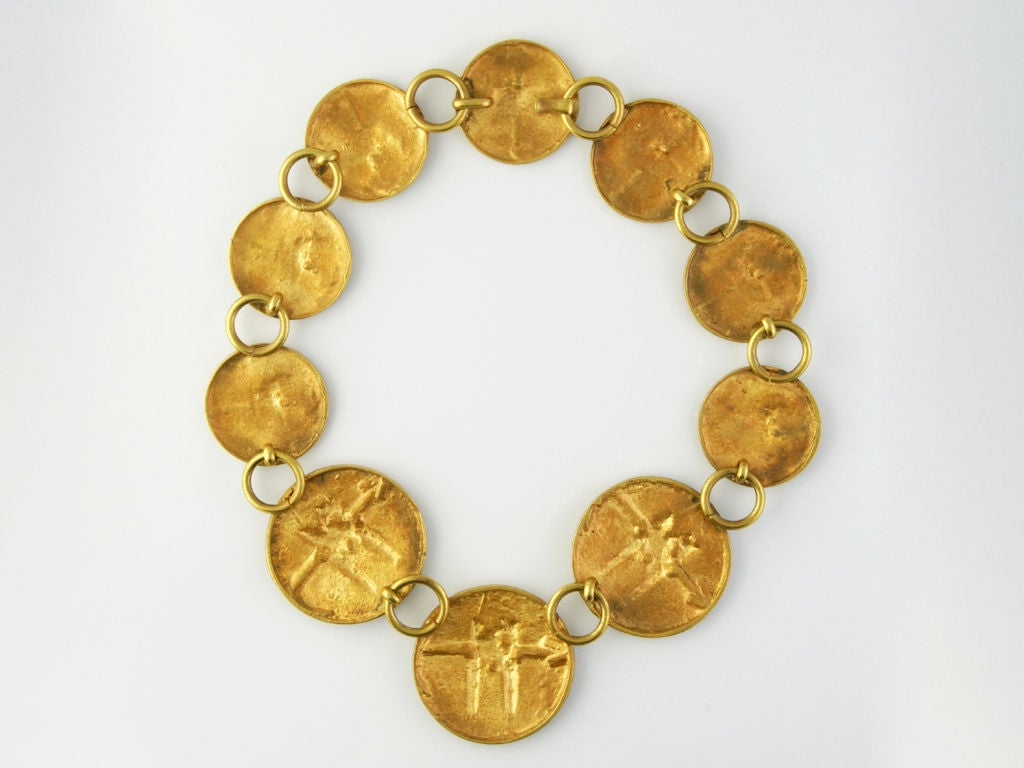 This hand made necklace, coming from Jeanne Peral's archives, is made of graduated size medallions with a horse rider on a horse in antique finish gilded broze.