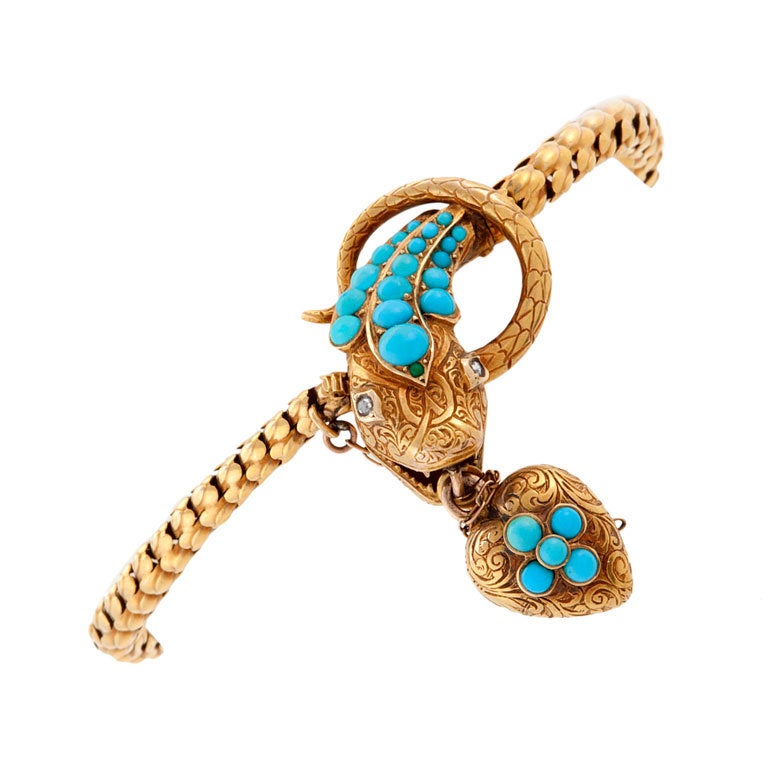 An English Victorian 15 karat gold bracelet with Persian turquoise and diamonds. The bracelet has 24 turquoise cabochons, and 2 rose-cut diamonds with an approximate total weight of .02 ct. carats.  The turquoise-set articulated heart has a locket