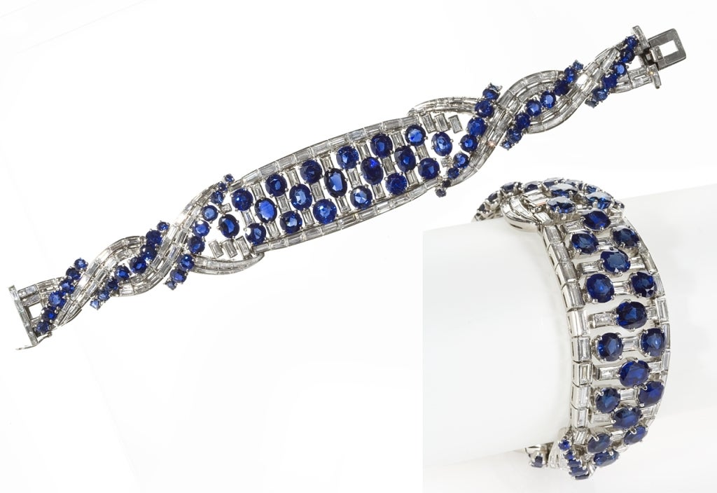 Combining fluidity and heft, this visually complex bracelet by Boucheron Paris embodies a streamlined mid-century aesthetic. Using alternating rows of richly-hued untreated blue sapphires and graduating diamond baguettes, Boucheron Paris employs the