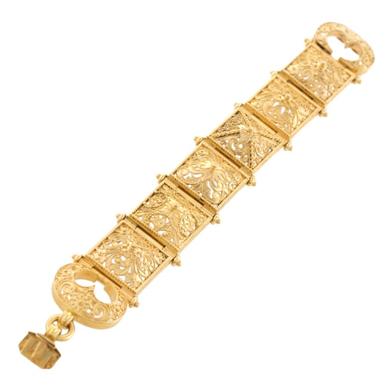 A French Antique 18 karat gold bracelet. The bracelet is composed of 6 pierced square foliate bombé plaques with a double buckle closure. 

Circa 1870. 

(MG #15524)