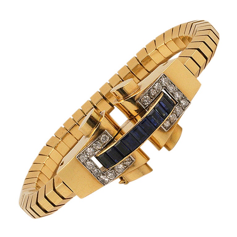 A French Retro 18-karat gold bracelet with blue sapphires and diamonds by Boucheron. The bracelet centers on 11 calibre-cut blue sapphires with an approximate total weight of 2.20 carats, and 20 round-cut diamonds with an approximate total weight of