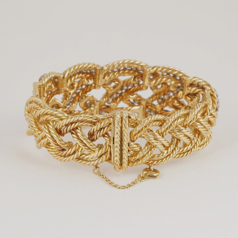 A French 18 karat gold and platinum bracelet with diamonds by Boucheron. The bracelet has 102 round-cut diamonds with an approximate total weight of 7.30 carats. The bracelet is composed of braided twisted gold rope diamond set. 

Circa 1960's.