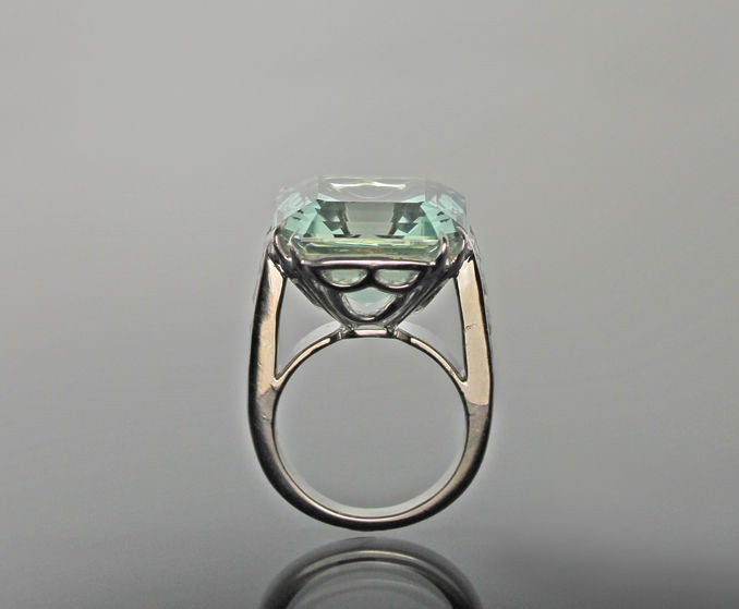Spectacular Asscher Cut Green Aquamarine set with double claws flanked by eight French Cut Diamonds in a Platinum mounting. Size 6 1/4. Sizeable.