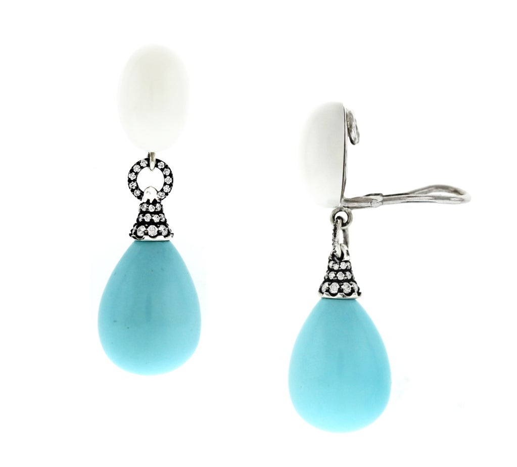 Large turquoise drops dangle from white coral cabs set in antiqued finish diamonds in silver-topped 18K gold. Clips. Posts can be installed upon request.