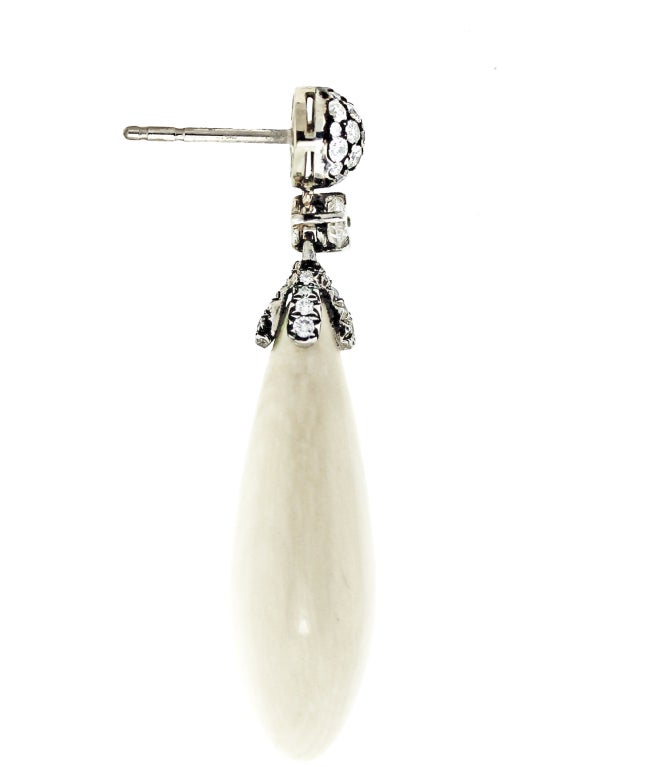 Polished Mammoth ivory suspended from diamonds. Posts.