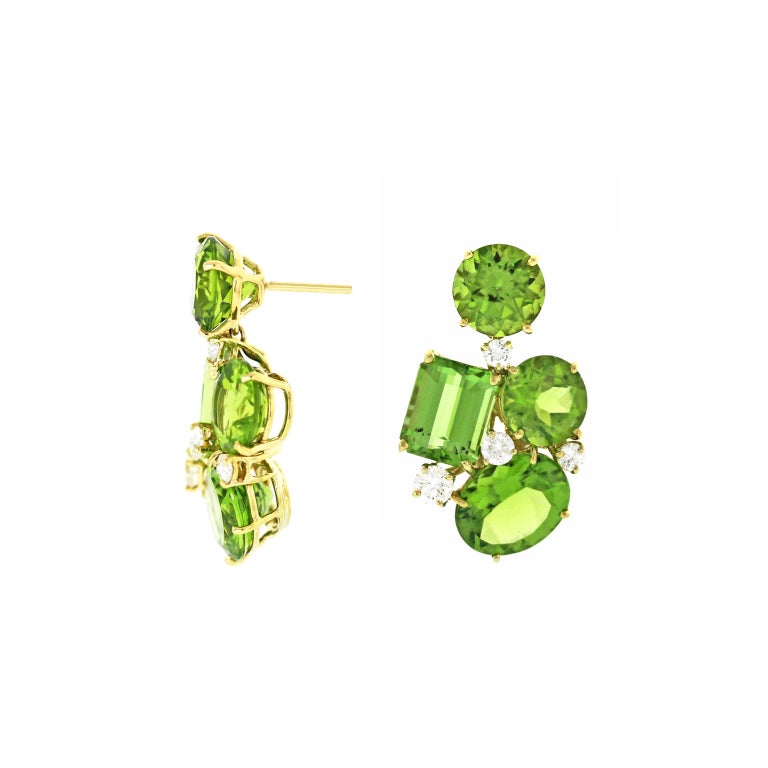Over twenty carats of spring green vibrant emerald cut, round and oval peridots and diamonds create a lively day to night earring.  Posts. 1 1/4