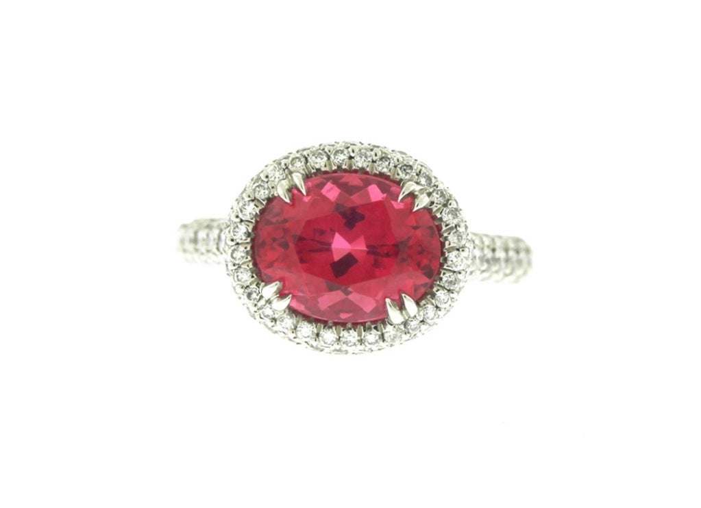 Vivid red spinel set horizontally in a beautifully detailed diamond pave platinum ring. Outstanding color, cleanliness and craftsmanship. Size 6 1/2 (can be altered somewhat).