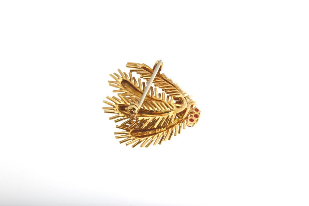 TIFFANY & CO. cactus brooch with rubies set in 18kt yellow gold.  Weight is 18 grams.
