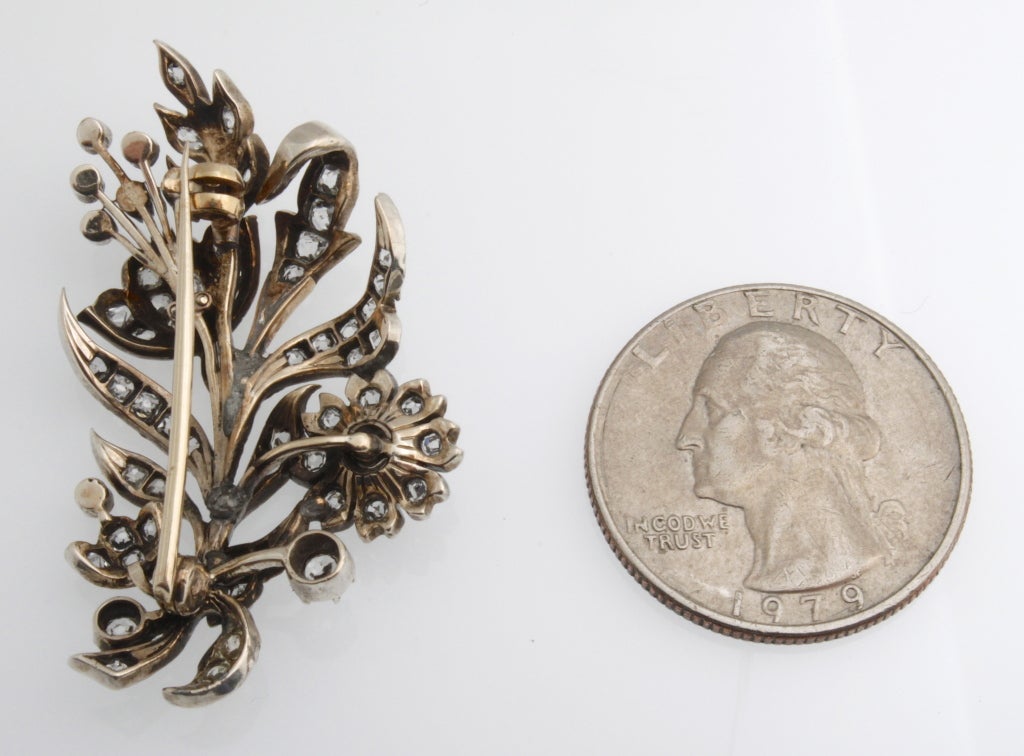 Early Victorian silver on gold diamond floral spray pin.