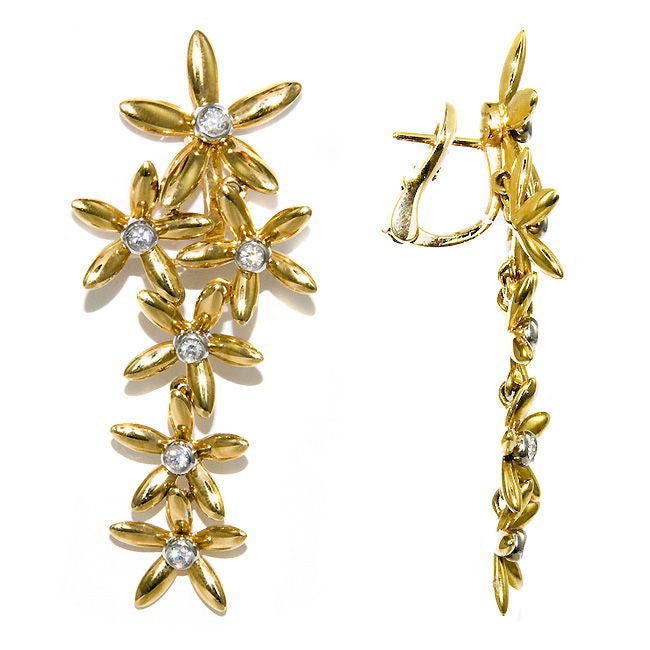 Elegant 18K Yellow Gold and Diamond Articlated Daisy Form Dangle earrings by Asprey, .65 Carat Total Diamond Weight with Omega clip backs. These Earrings are new in original box with original price tag of $5790.00
