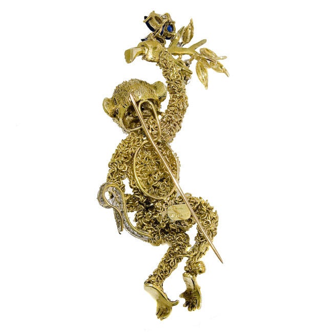 Wonerful, large hand made Monkey form brooch of 18K yellow gold, set with Diamonds and sapphires.