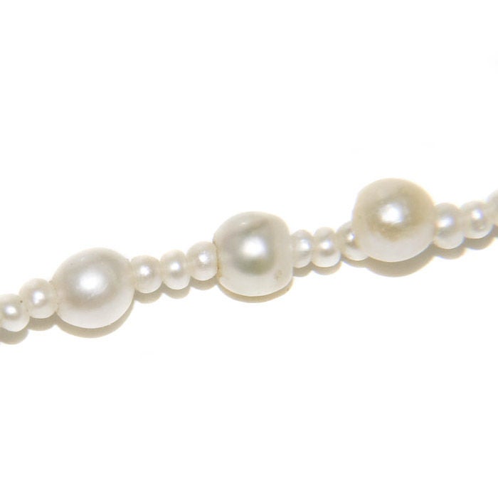 Strand of Natural Pearls, measuring 1.5 to 5 M.M. with a Platinum Clasp. With Original 1933 document stating that the Pearls were the property of Grand Duchess Olga Romanov, Oldest Daughter of Tsar Nicholas Romanov. These Pearls were worn by The