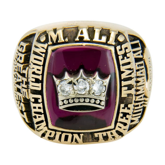 This is Muhammad Ali's 1978 3 Time World Championship Ring, the ring is 10K Yellow gold with a Red stone and topped with a White Gold Crown, set with 3 Diamonds. This ring comes with a letter typed and signed by Muhammad Ali, pictures of the