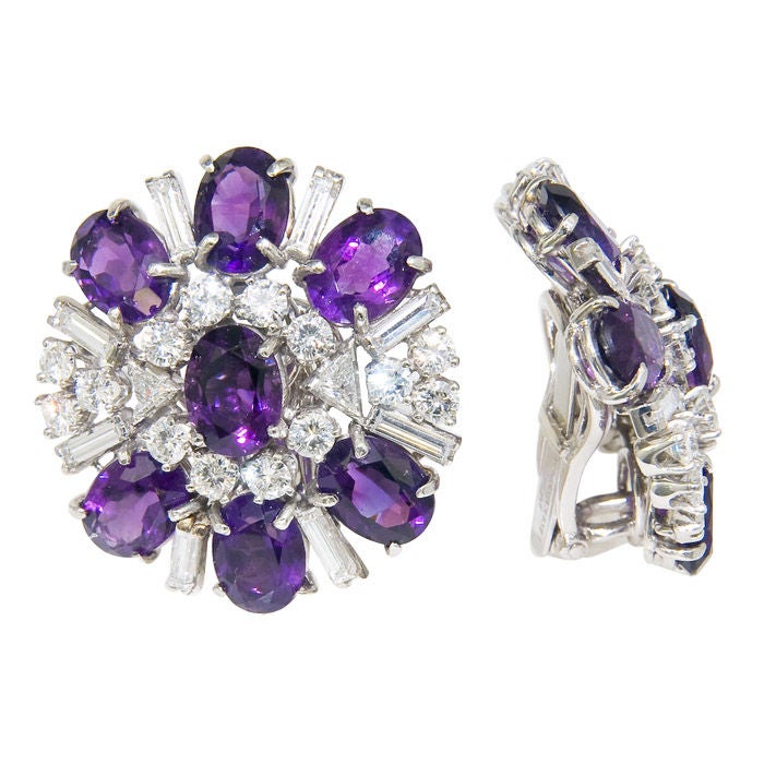 Stunning pair of Platinum, Diamond and Gem Color, Amethyst Ear Clips from the Heyday of Hollywood jewels!! Signed Laykin Et Cie and containing 3 Cartas of Round, Baguette and Triangle Diamonds.