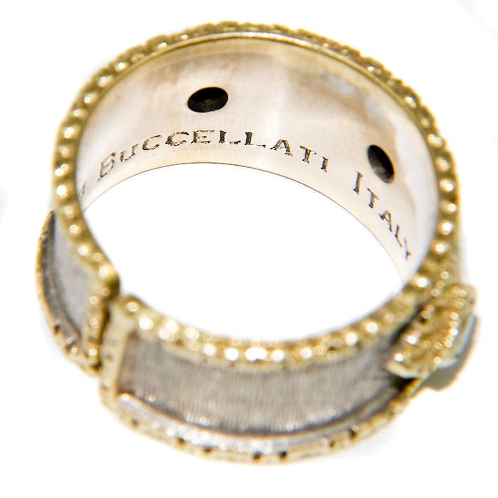 18K Yellow and White Gold Ring By Buccellati, hand textured finish and set with 3 round brilliant Diamonds, totaling .30 Ct. Finger size = 6, bottom of shank is adjustable and will fit a size 6 1/2 also.