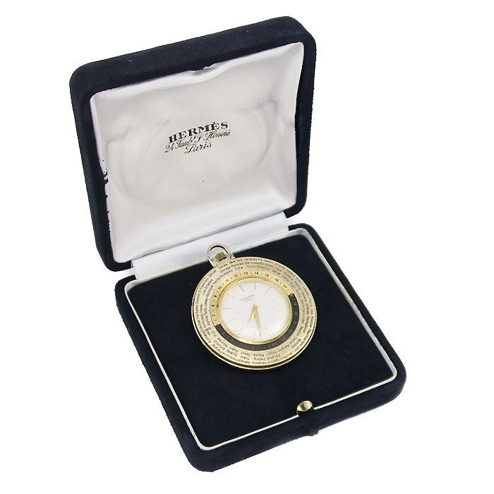 Hermes, World Time Pocket watch, yellow metal case with rotating bezel, white dial with raised gold Markers, Swiss 17 Jewel Manual Wind Movement. original Hermes Box.
