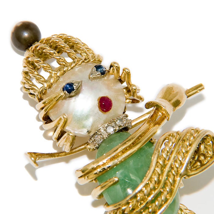 Very Whimsical Lady Golfer brooch, 18K Yellow Gold, Cabachon Emerald Body, Pearl head, Sapphire Eyes and Ruby mouth, further accented with Diamonds.