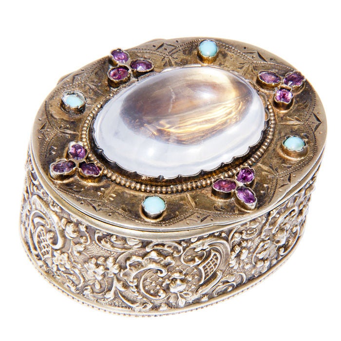 900 Silver Snuff box having a Gold Wash interior, top is set with a large Moonstone and further set with Turquoise and Rhodolite Garnets.