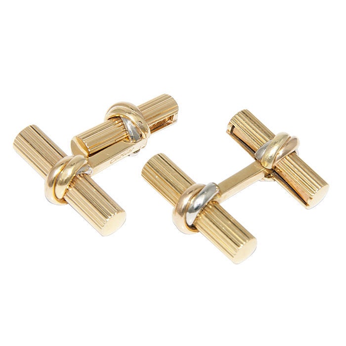 Cartier, 18K yellow Gold Cufflinks from the Trinity Collection, with tri Color Gold Bands. Signed and Numbered.