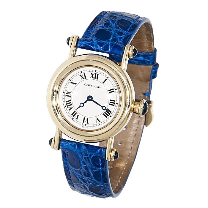 Ladies, Cartier 18K yellow Gold Diablo Wrist watch, Quartz Movement,Cabachon Sapphire set Lug Ends and Crown, Gold Cartier Buckle and Cartier Blue Strap.