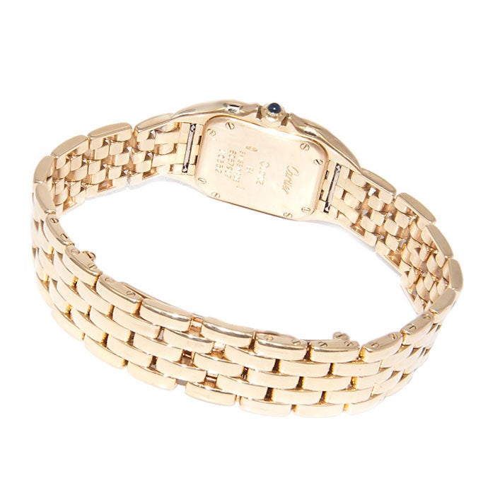 Lady's 18k yellow gold Panther bracelet watch. Panther link bracelet with deployant buckle, quartz movement, white dial, Roman numerals, sapphire-set crown.