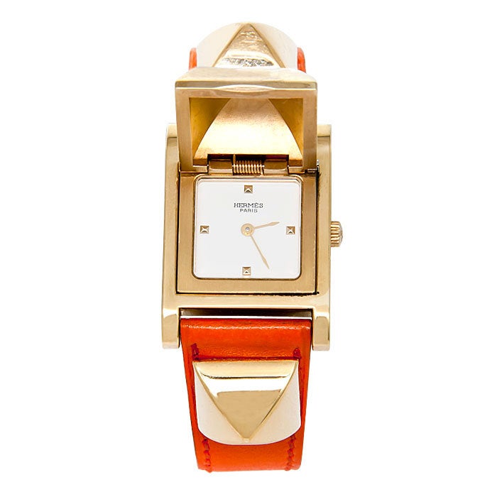 Ladies Hermes medor Wrist Watch, Gold Tone on Orange strap, Quartz movement, Showing very Minor signs of any wear, this watch comes with original boxes and certificates.