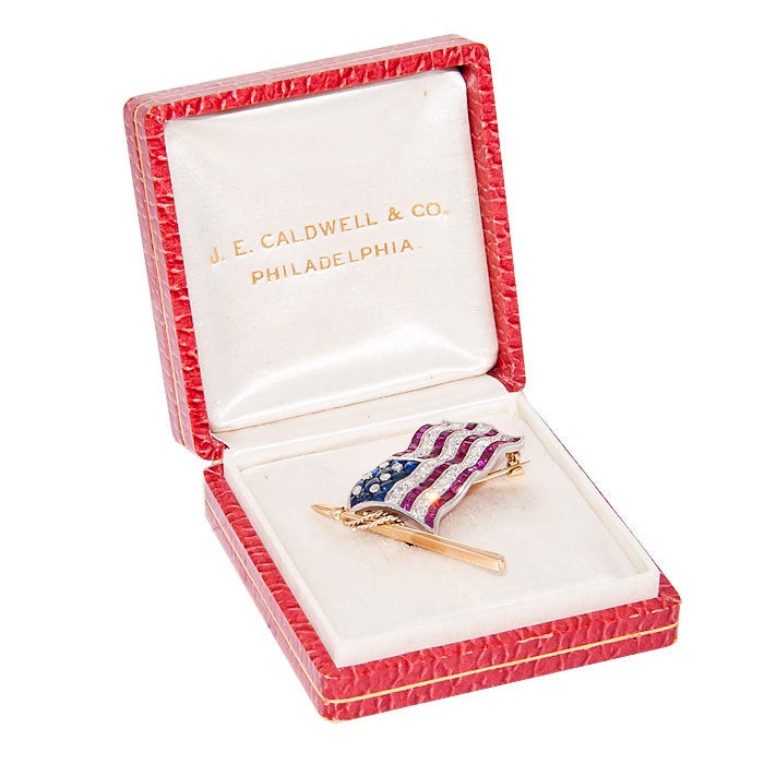 Very Cool, Patriotic flag brooch by J. E. Caldwell, in original box. Diamonds Caliber cut Rubies and Buff cut Sapphires.