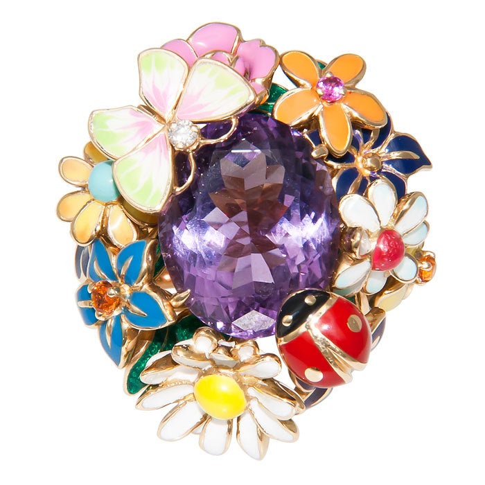 The Famous Diorette Ring by Christian Dior, 18K yellow Gold with Enamel Flowers, Lady Bug and Butterfly, centrally set with an oval Amethyst. Color Gem stone accents in the flowers. Signed and Numbered, Finger size = 6 1/2. This ring comes with the