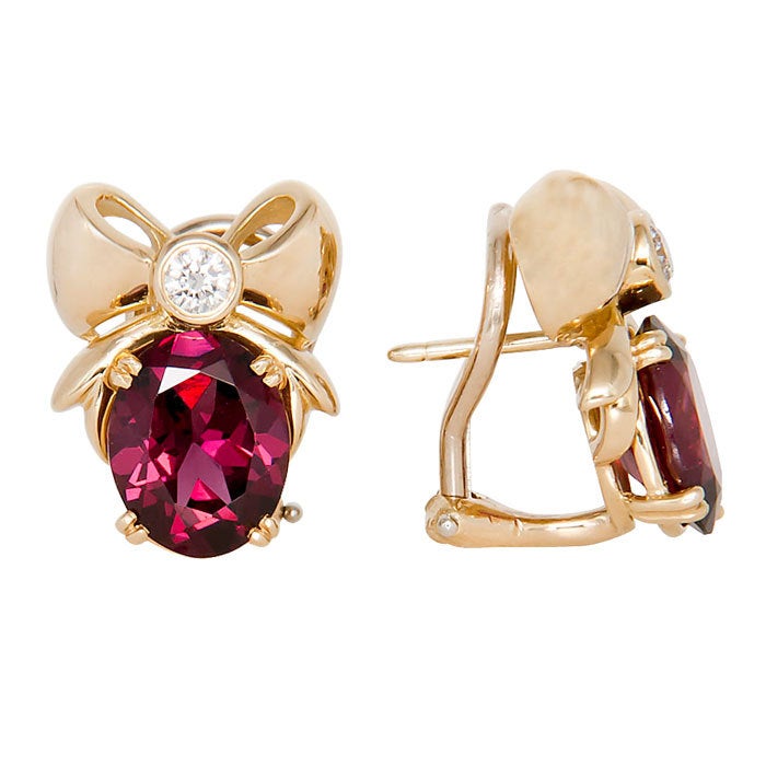 Tiffany & Company 18K Yellow gold Ribbon Earrings set with Rhodolite Garnets, approximately 3 carats each. Further set with round brilliant cut Diamonds weighing .15 Carat each. Post backs with Omega Clip. Original tiffany Box.1/4  X  3/4 Inch