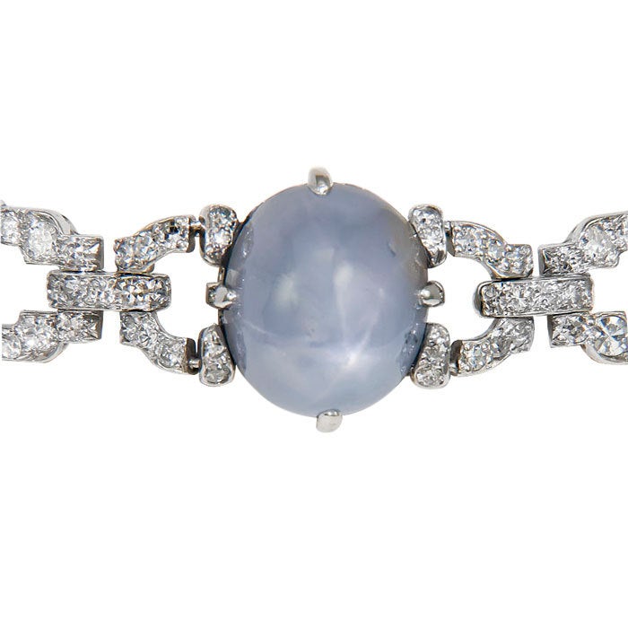 Platinum Art Deco Bracelet set with 5 Carats of Round and Baguette Diamonds, further set with 5 Star Sapphires of Medium Blue Color and weighing approximately 12 Carats. This Bracelet is numbered on the clasp and tongue.