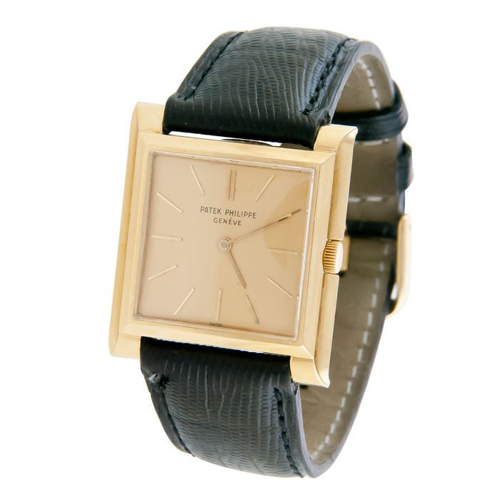 Classic Patek Philippe, Ref. 2562, in an 18k yellow gold stepped square case. Original mint condition gilt dial with raised gold markers. 18-jewel manual-wind movement. Signed and numbered case and movement.